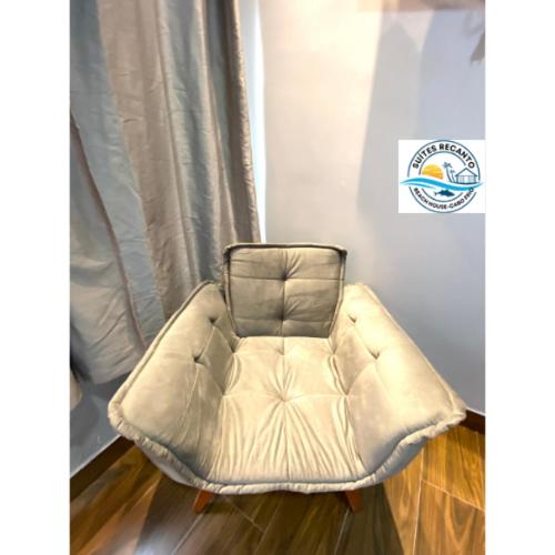 a white bean bag chair in a room with a window at Pousada Recanto Beach House-CaboFrio-Unamar-condominio Florestinha in Cabo Frio
