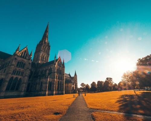 a large building with a church in a field at Milford Hall Salisbury in Salisbury