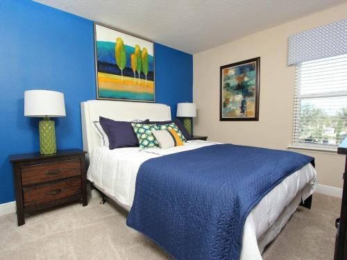 a bedroom with a bed and a blue wall at ACN4308 in Bemidji