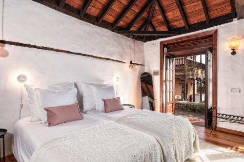 a bedroom with a large white bed with two pillows at Tango by Huskalia in Breña Alta