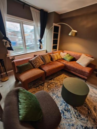 a living room with a couch and a chair at Alkmaar canal apartment in Alkmaar