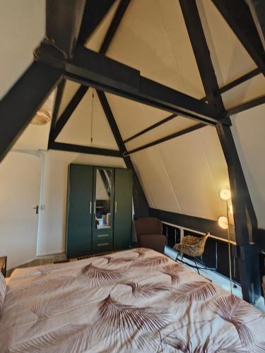 a bedroom with a large bed in a tent at Alkmaar canal apartment in Alkmaar