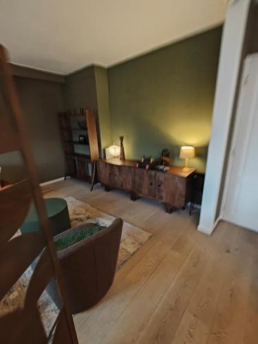 a living room with a couch and a desk at Alkmaar canal apartment in Alkmaar
