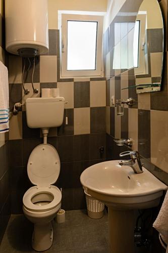 a bathroom with a toilet and a sink at Apartments M&Z in Budva