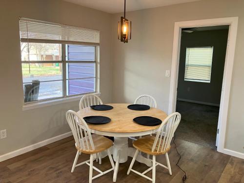 a dining room with a table and four chairs at The Purple House - Cozy Near TSU in Stephenville