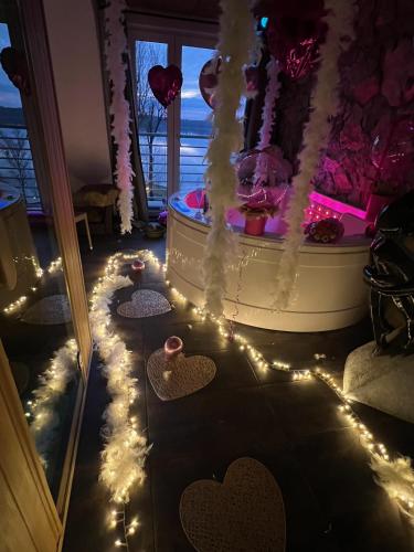 a room with a tub with hearts and lights at EGZOTYCZNO - ROMANTYCZNE miejsce dla DWOJGA in Ełk