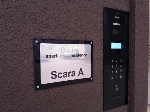 a remote control attached to a wall with a sign at Sophia Studio in Iaşi