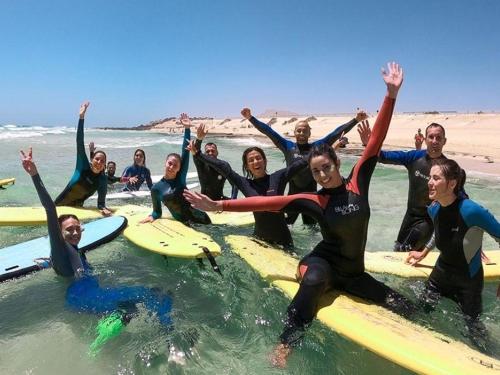 a group of people in the water on surfboards at Four Seasons Apartment in Agadir