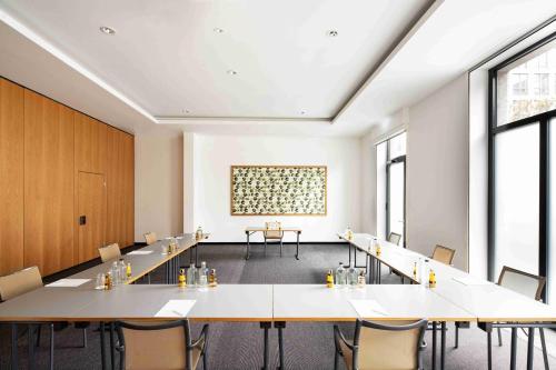 a large room with tables and chairs in it at Holiday Inn Frankfurt - Alte Oper by IHG in Frankfurt/Main