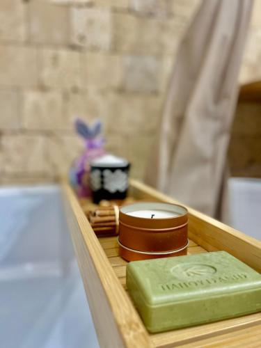 a wooden tray with a green bar of soap on it at Saints & Sinners Romantic Jacuzzi in Bucharest
