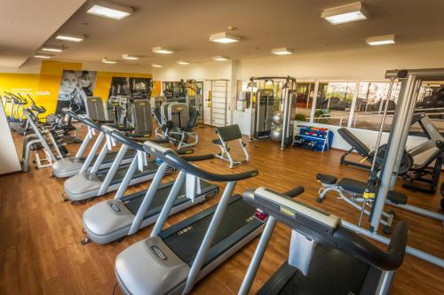 a gym with a row of cardio machines at Bourbon Resort Atibaia in Atibaia