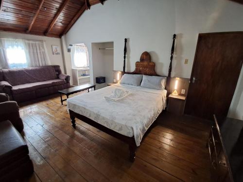 a bedroom with a large bed and a couch at Mom's Place Negril in Negril