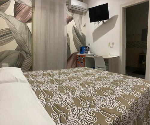 a bedroom with a bed and a desk and a television at Casa Vella Apartment in Agrigento