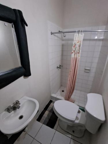 a bathroom with a toilet and a sink at Mom's Place Negril in Negril