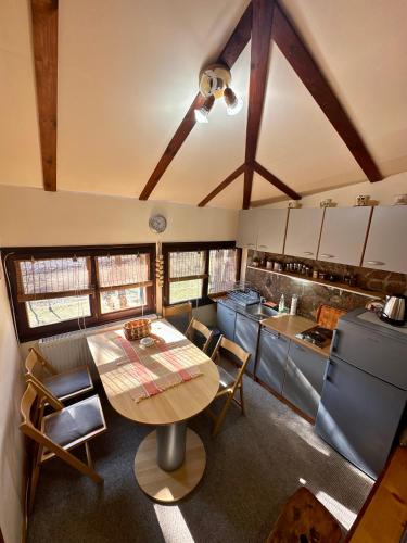 a kitchen with a table and chairs in a room at Micic Apartment 3 Divcibare in Divčibare