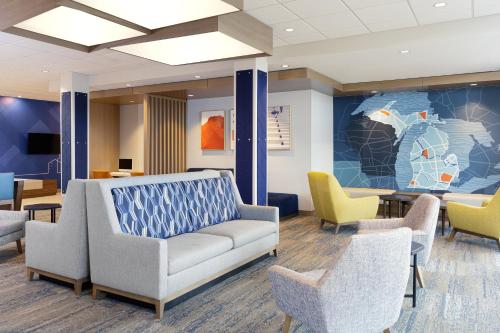 a waiting room with a couch and chairs at Holiday Inn Express & Suites Clarksville North by IHG in Clarksville
