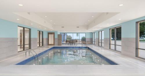 a swimming pool in a house with windows at Holiday Inn Express & Suites Clarksville North by IHG in Clarksville