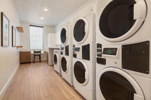 a row of washing machines in a laundry room at Staybridge Suites Southaven - Memphis South by IHG in Southaven