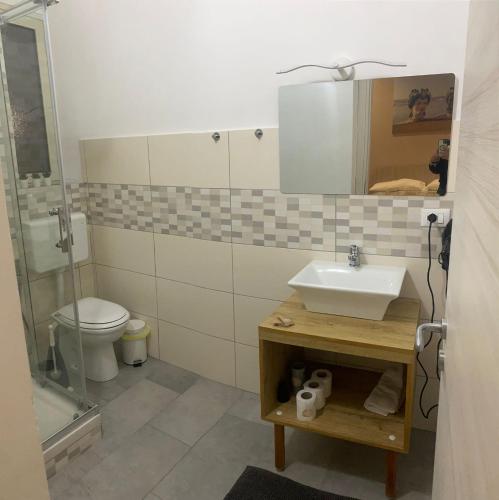 a bathroom with a sink and a toilet at Casa Vella Apartment in Agrigento