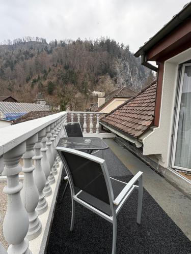 a balcony with a table and chairs on a house at Esos Hotel Quelle in Bad Ragaz