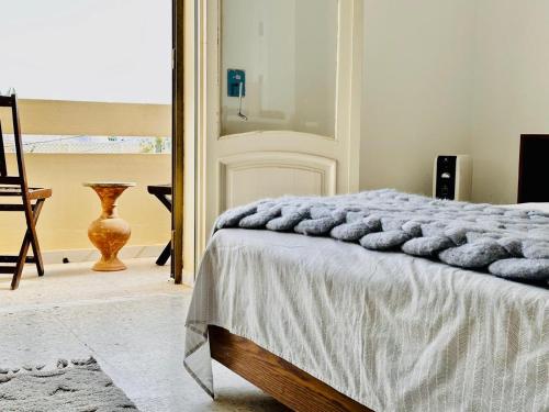 a bedroom with a bed and a mirror at Villa Olivier in Sakiet ez Zit
