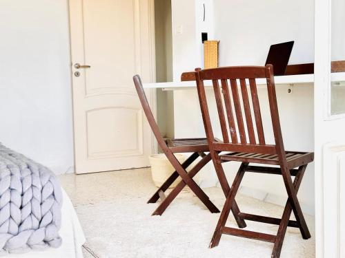 a wooden chair sitting in front of a desk at Villa Olivier in Sakiet ez Zit