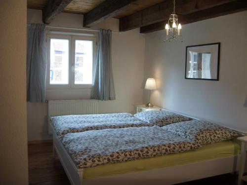 a bedroom with two beds and a window at Ferienhaus Münzenberg 53 in Quedlinburg