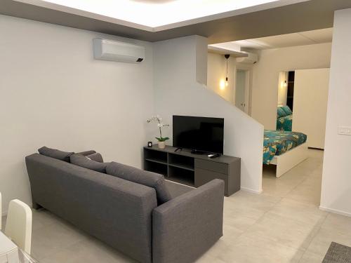 a living room with a couch and a flat screen tv at NEW Residenza le Essenze - i 7 Laghi in Erba