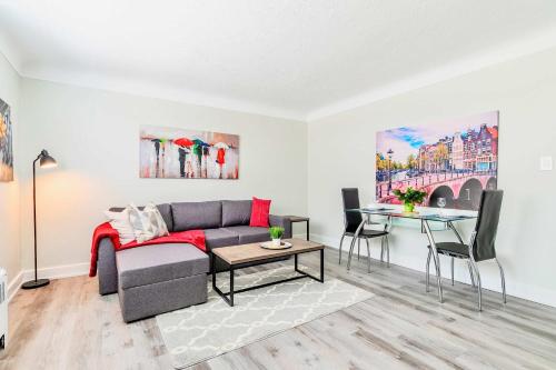 a living room with a couch and a table at Modern Apartment in Corktown Hamilton Sleeps 4 in Hamilton