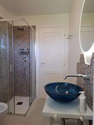 a bathroom with a blue sink and a shower at Le Mimose Garden in Bordighera