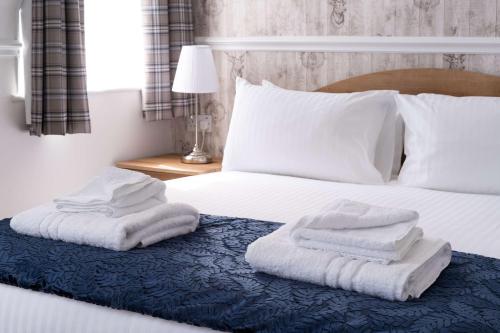 a bedroom with a bed with towels on it at The Lakeland Kendal Hotel, Sure Hotel Collection by Best Western in Kendal