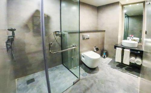 a bathroom with a shower and a toilet and a sink at Best Western Hotel Rawalpindi Central in Rawalpindi