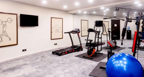 a gym with treadmills and exercise equipment on a wall at Best Western Hotel Rawalpindi Central in Rawalpindi