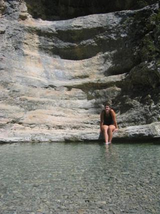 a man sitting in the water next to a mountain at "Le Vent d'Étoile" B&B and Guesthouses in Mormoiron