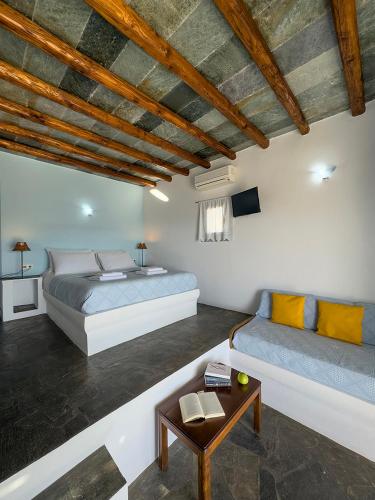 a bedroom with two beds and a table at Anatoli in Ano Meria