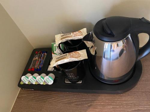 a coffee pot sitting on a black tray with coffee cups at Chelsea Guest House in London