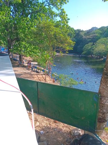 a body of water with people swimming in it at Cabaña de Lucas in Loma Bonita