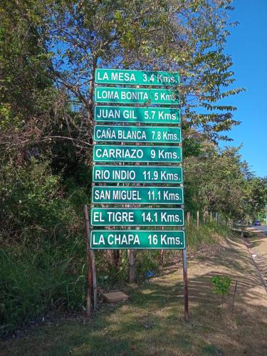 a street sign with many different signs on it at Cabaña de Lucas in Loma Bonita