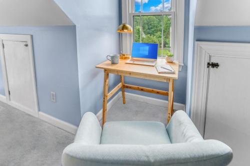 a room with a desk with a laptop and a chair at 5BD Family Oasis, Pool, FirePit, Bball, Pong in High Point