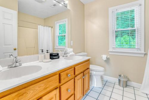 a bathroom with a sink and a toilet at 5BD Family Oasis, Pool, FirePit, Bball, Pong in High Point