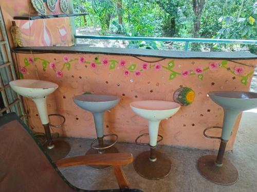 a room with three stools and a window at Cabaña de Lucas in Loma Bonita