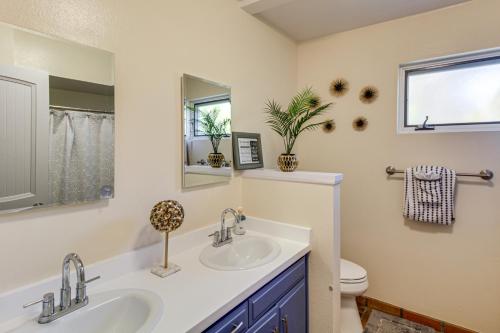 a bathroom with two sinks and a toilet at Private Pool & Fire Pit! Walkable Tucson Retreat in Tucson