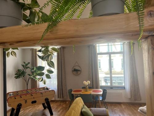 a living room with a ping pong table and a window at L'Original - Villa Courtais - Hypercentre in Montluçon