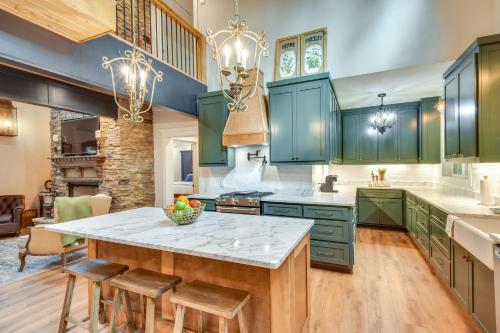 a kitchen with green cabinets and a large island at Luxurious Clarkesville Cabin with Decks and Fire Pit in Clarkesville