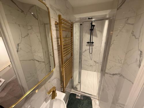Un baño con ducha, lavabo e inodoro. en Luxe Guesthouse, en Stoke on Trent