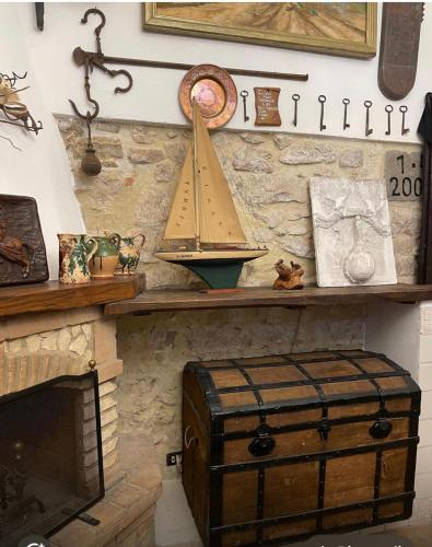 a shelf with a toy boat on top of a fireplace at Il Carpino Historic Luxury Home - dimora con sauna in Carpineto Romano