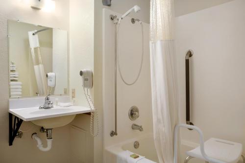 a bathroom with a sink and a shower at Super 8 by Wyndham Alexandria MN in Alexandria