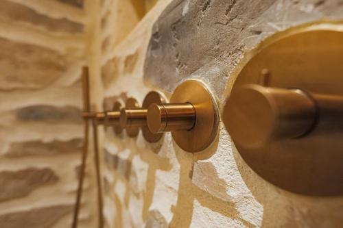 a wall with a wooden door knob on a stone wall at Suite Deluxe & Spa #Wabi-Sabi# in Bray-Dunes