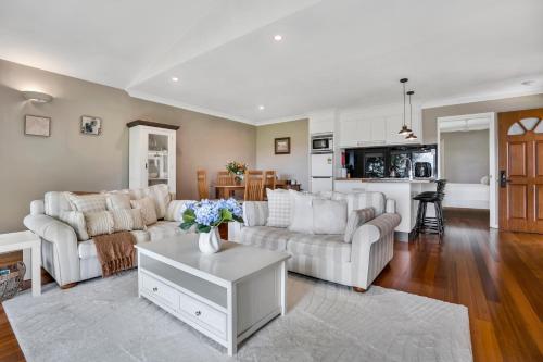 a living room with two couches and a table at The Avenue at Montville Cottage in Montville