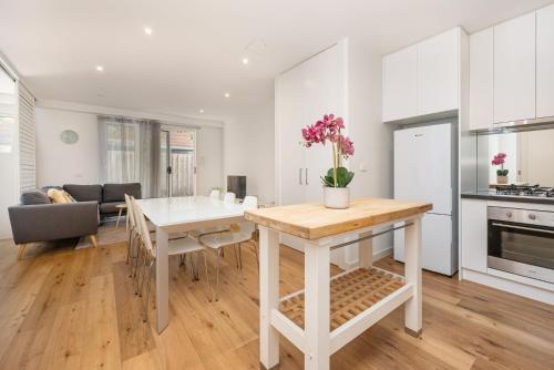 a kitchen and living room with a table and a dining room at Convenience and Comfort in Carnegie in Carnegie